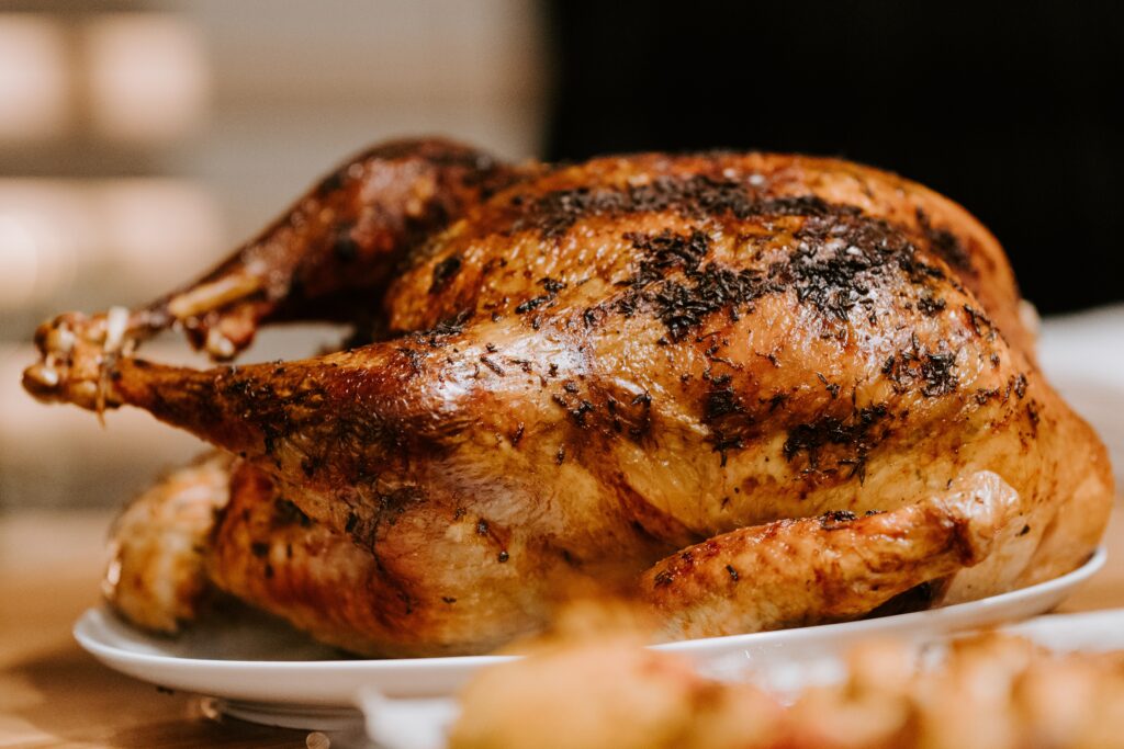 A picture of a whole roasted or baked turkey served on a platter