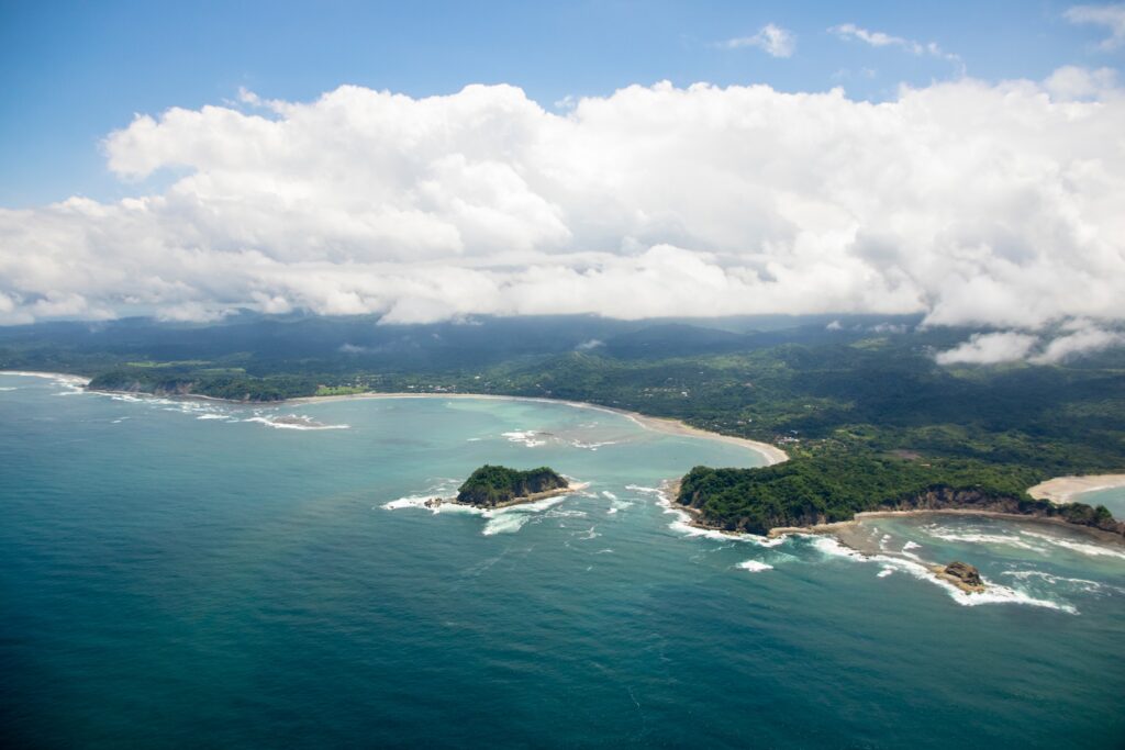 aerial picture of coast area and aquamarine sea