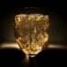 A-glass-of-golden-bubbly-sparkling-champagne-against-a-dimly-lit-background