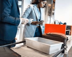 passengers-going-through-airport-security-removing-their-shoes-and-belongings