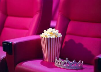 pink-cinema-seats-with-popcorn-cartridge-and-queen's-silver-crown-on-one-of-the-seats